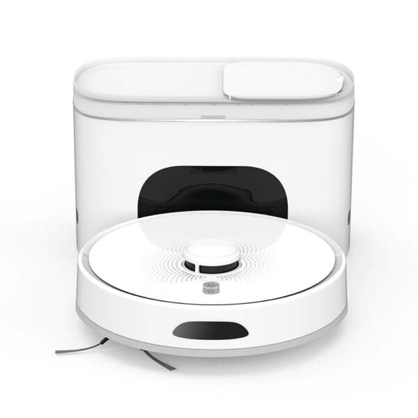 A white Dottie Robot Vacuum and Mop, with a cylindrical shape, is positioned in front of its charging and cleaning dock. The sleek, minimalist dock includes a small opening for the vacuum. The Dottie Robot Vacuum and Mop features sensors and a small brush on its underside as well as mop capabilities for thorough cleaning.