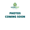 A green background with the HomeBot Ireland logo at the top, featuring a house outline with a smiley face inside. Below the logo, bold blue text reads "PHOTOS COMING SOON."